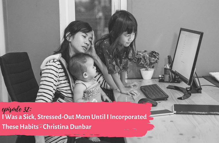 tired mom sitting at computer with two young children